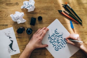 Hands designing calligraphy text